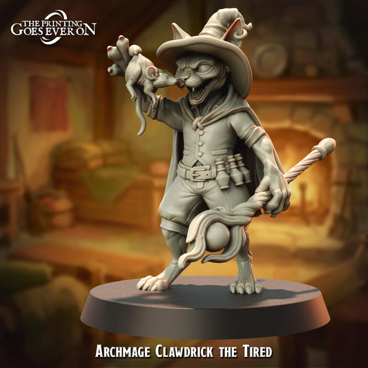 a statue of a cat-like creature with a pointed hat and a staff, standing on a platform and holding a small object in its hand.