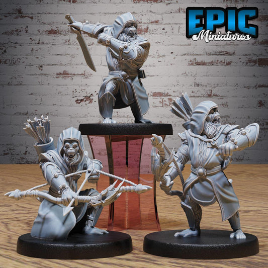 three figurines of soldiers, each holding different weapons such as swords, bows, and spears. The figurines are displayed on a wooden surface against a brick wall background.