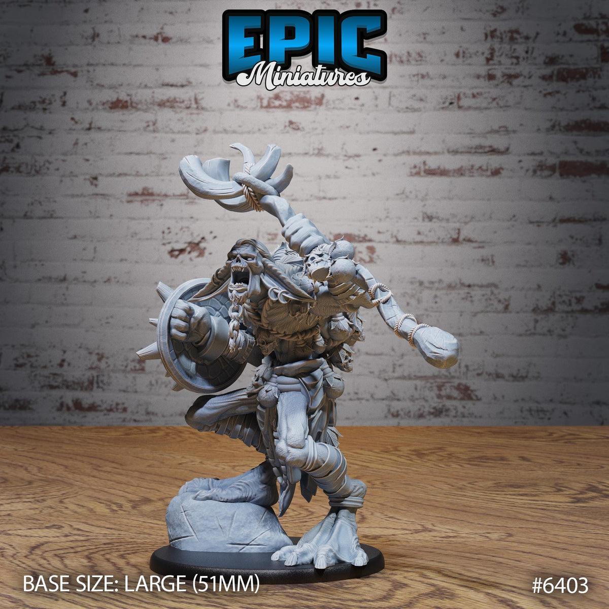 A figurine of a fierce-looking monster or dragon-like creature, with a large and imposing appearance, is displayed against a brick wall background.