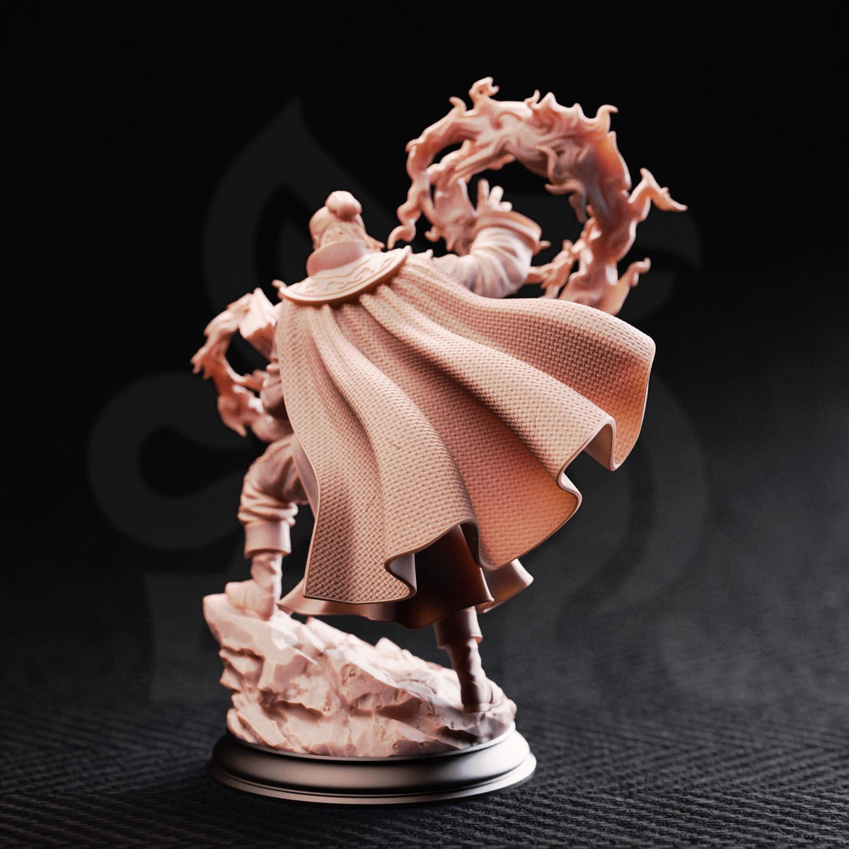 A figurine of a person in a flowing robe, holding a wreath, standing on a rock against a dark background.
