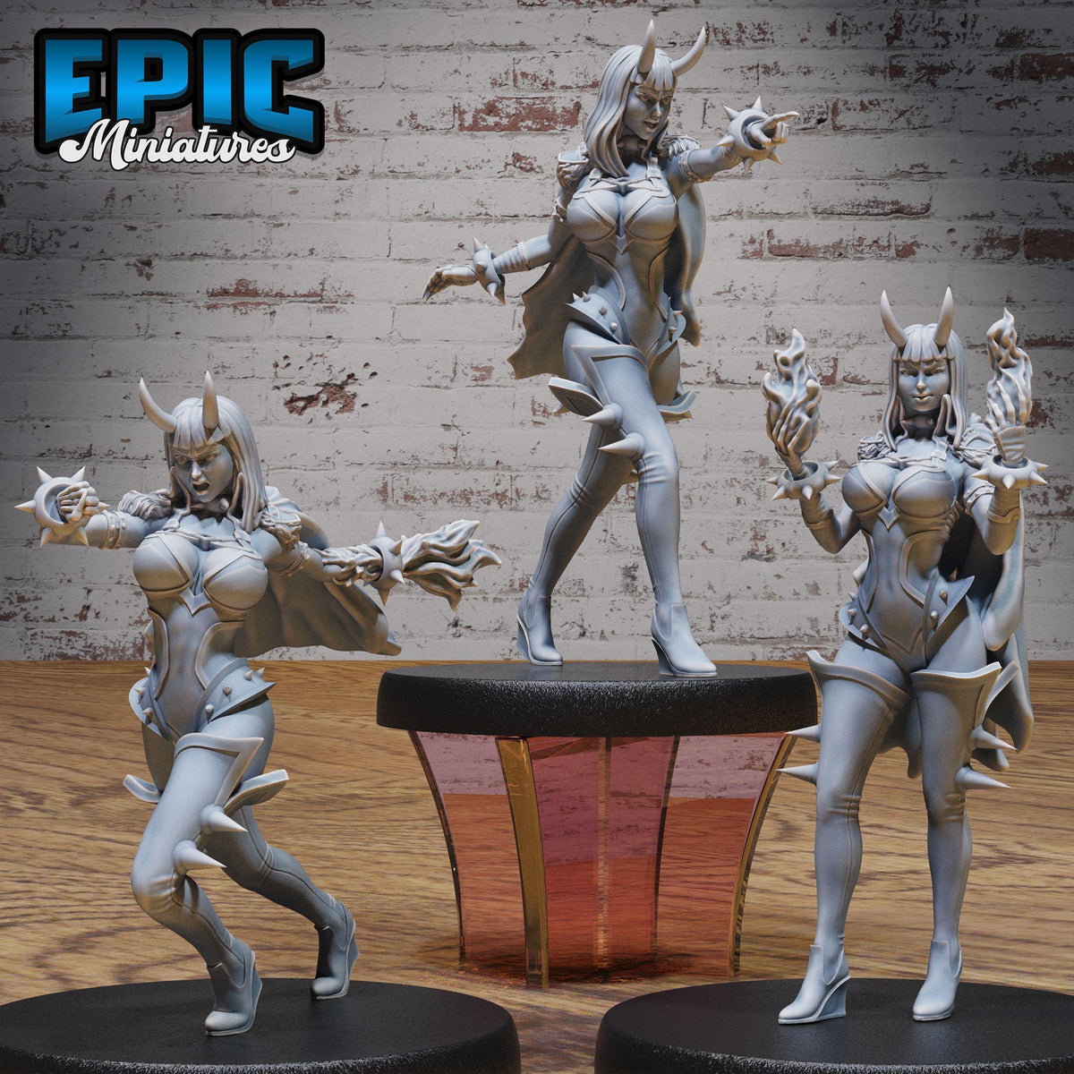 three figurines of women in fantasy costumes, each with unique poses and expressions, set against a brick wall background.