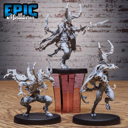 three detailed figurines of fantastical creatures, including a large dragon-like creature with horns and sharp claws, two smaller creatures with horns and sharp claws, and a creature with a long tail and sharp claws. The figurines are displayed on a wooden surface, with a brick wall in the background.