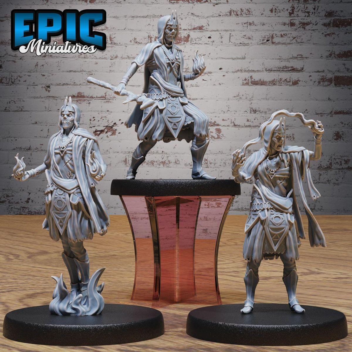 three figurines of characters from a fantasy or science fiction setting, displayed on a stand against a brick wall background.
