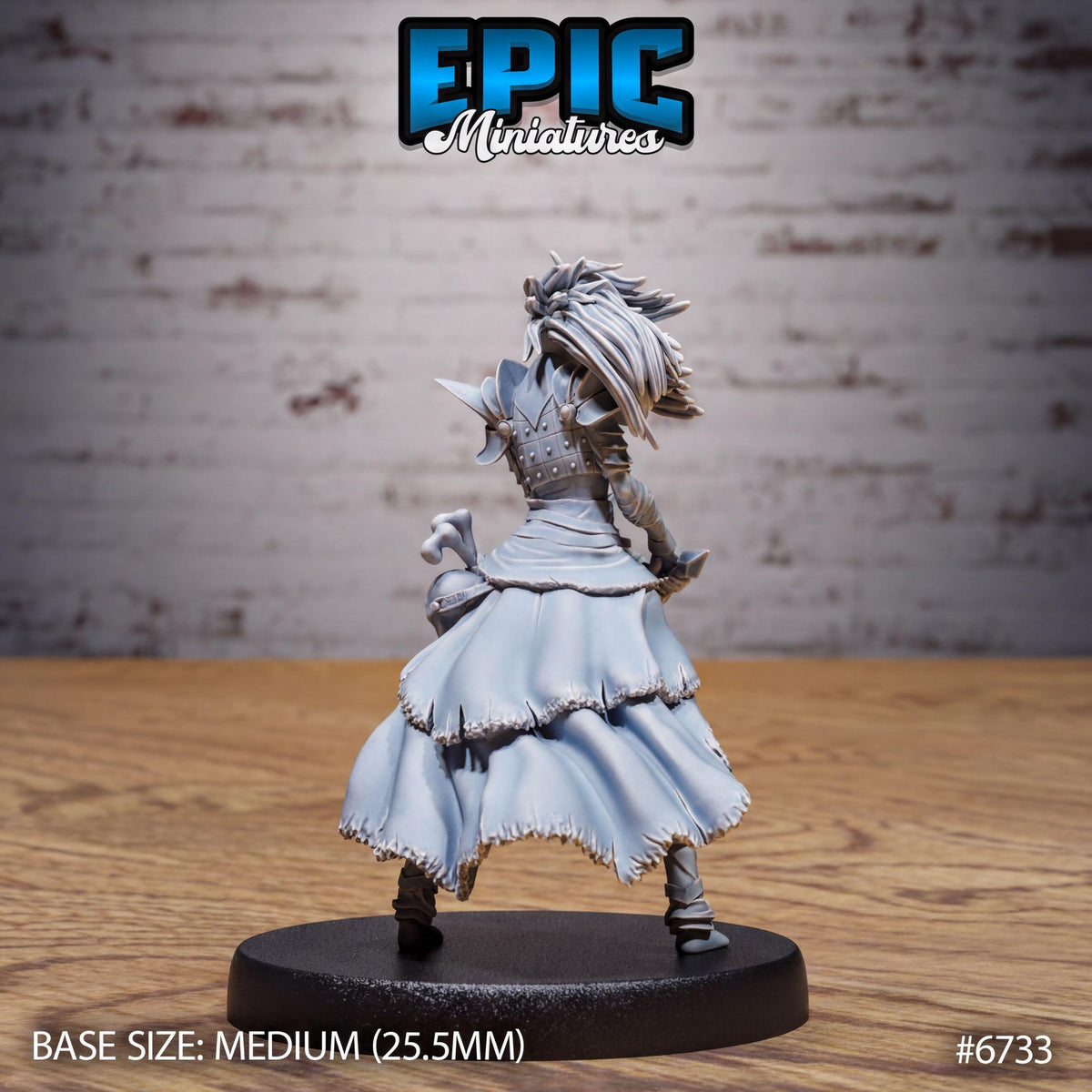 A figurine of a female character in a flowing dress, standing on a black base.