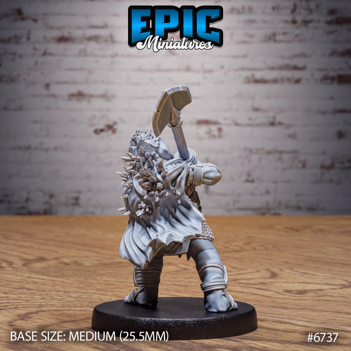 A figurine of a warrior standing on a base, holding a weapon, against a brick wall background.
