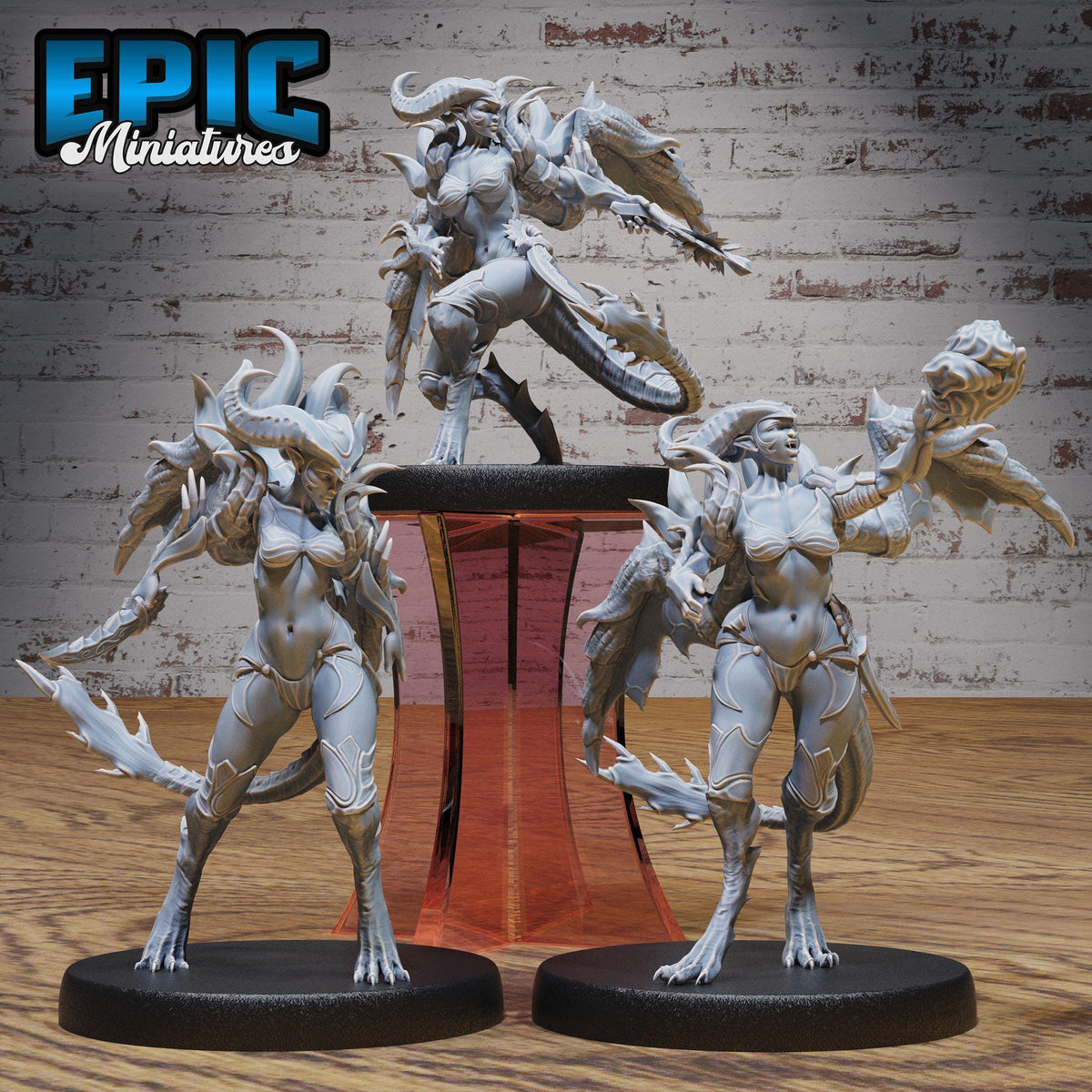 three detailed figurines of fantastical creatures, including a dragon-like creature, a winged creature, and a human-like figure, all posed on pedestals.