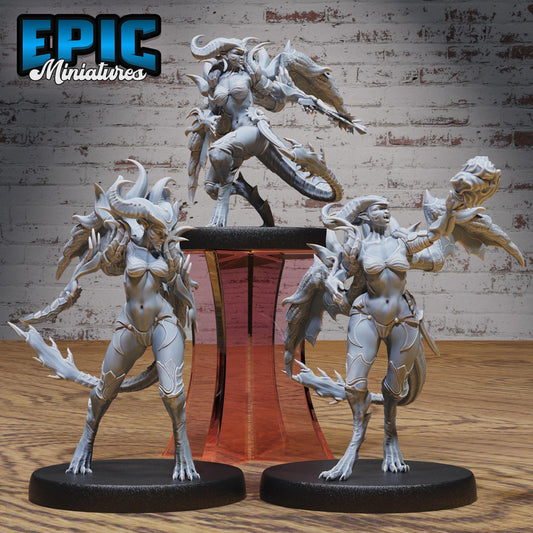 three detailed figurines of fantastical creatures, including a dragon-like creature, a winged creature, and a human-like figure, all posed on pedestals.