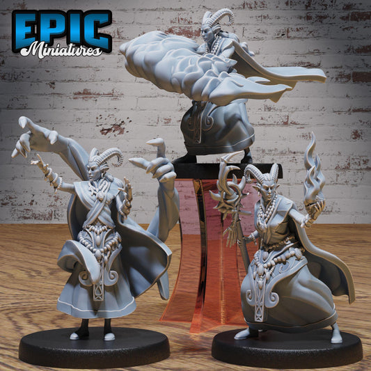 three detailed figurines of fantasy characters, including a dragon-like creature, a human-like figure with horns, and another human-like character with a staff. The figurines are displayed on stands, and the background includes a brick wall.