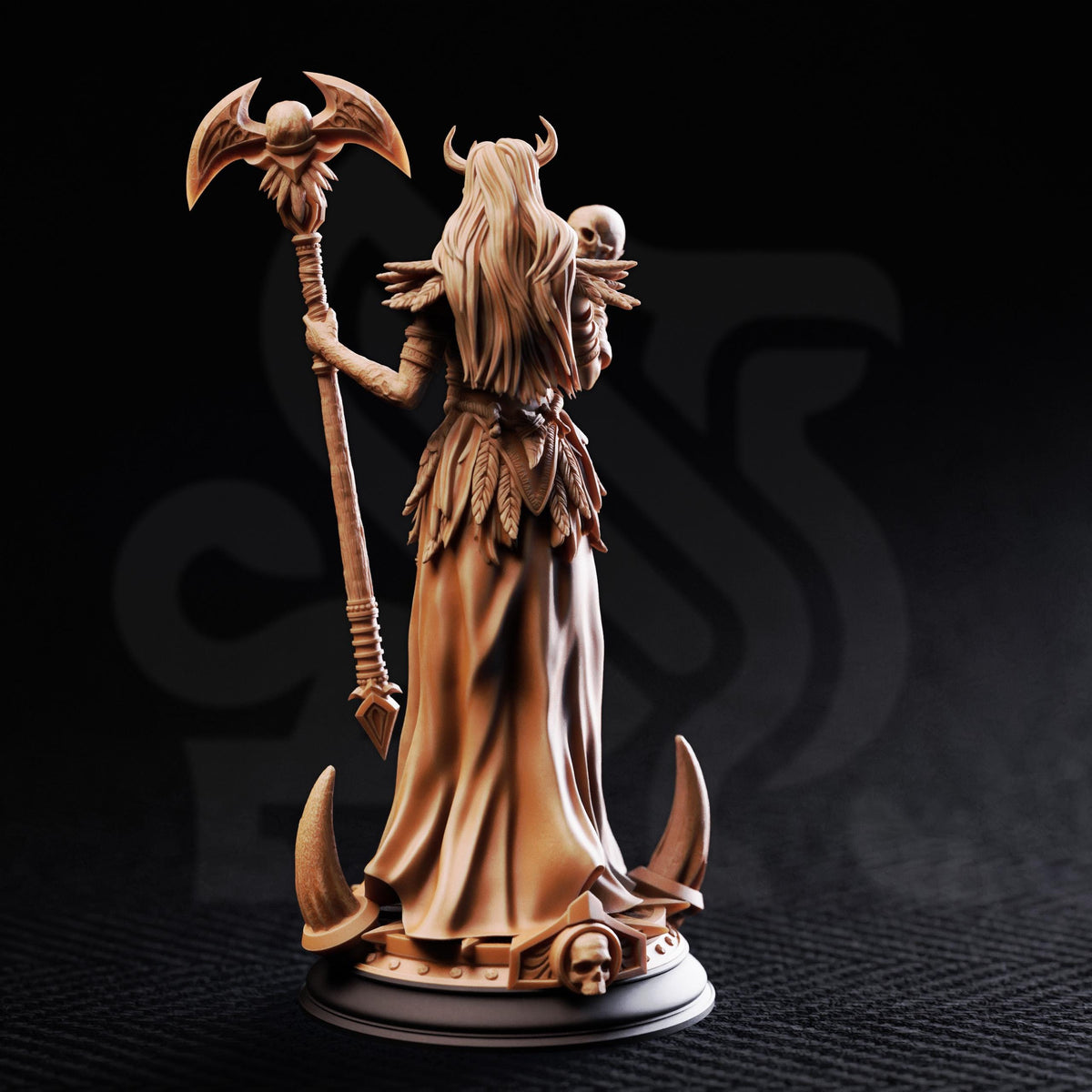 A detailed figurine of a female figure with long hair, wearing a flowing dress and holding a staff, standing on a platform with a skull at the base.