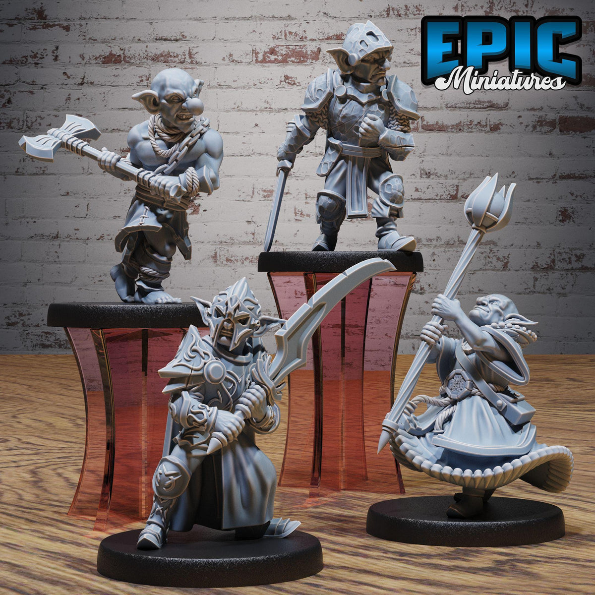 three figurines of fantasy characters, each holding different weapons, displayed on stands against a brick wall background.